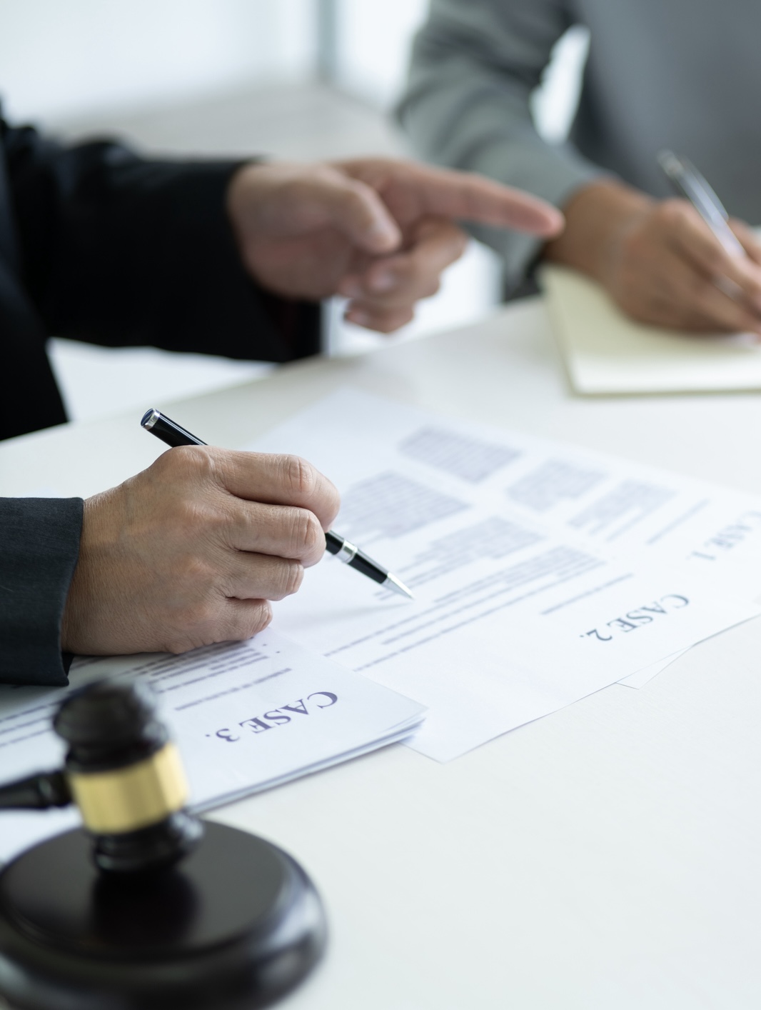 Lawyer is giving advice and Introduce a pending case to an assistant or a client who is writing down advice in a notebook as a guideline for finding legal procedures
